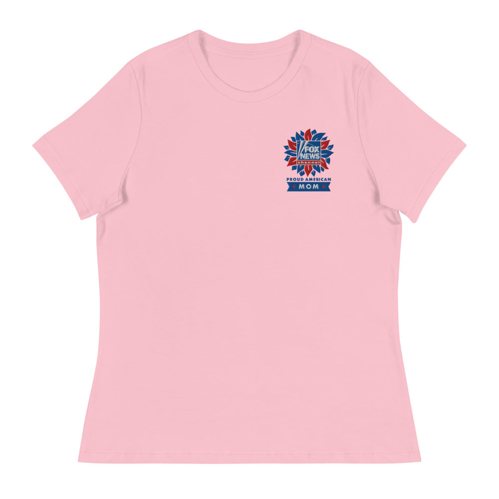 A lifestyle portrait of an everyday American woman wearing the heather prism natural FOX News t-shirt indoors.