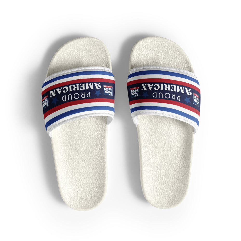A pair of FOX News Proud American Women's Slides displayed in a clean, sunlit American backyard setting.