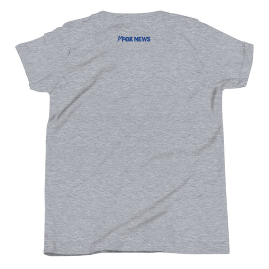 A young child wearing the white FOX News Proud Little American t-shirt while playing in a sunny suburban backyard.