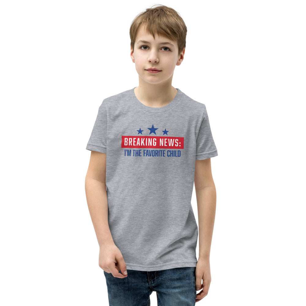 A child playing outdoors while wearing the comfortable FOX News Breaking News Kids T-Shirt in Athletic Heather.