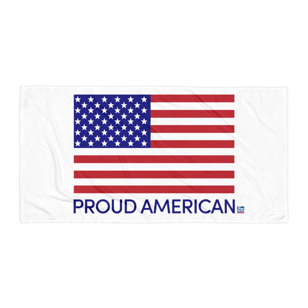 A FOX News Proud American Beach Towel laid out on a lounge chair in a clean, suburban American backyard by a pool. The red, white, and blue logo is crisp and clear.