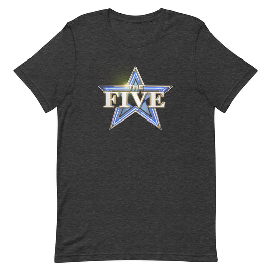 A modern American living room with a neutral-toned sofa, showing a front view of the Dark Grey Heather The Five Logo T-Shirt neatly folded on a coffee table.