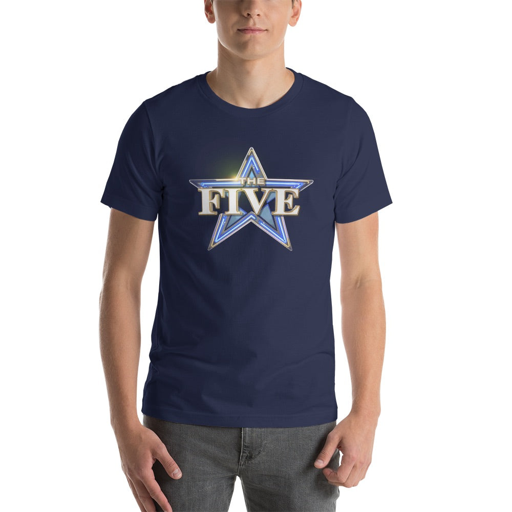 An outdoor patio setting with an American flag softly blurred in the background, showing an American man wearing the Navy The Five Logo T-Shirt.