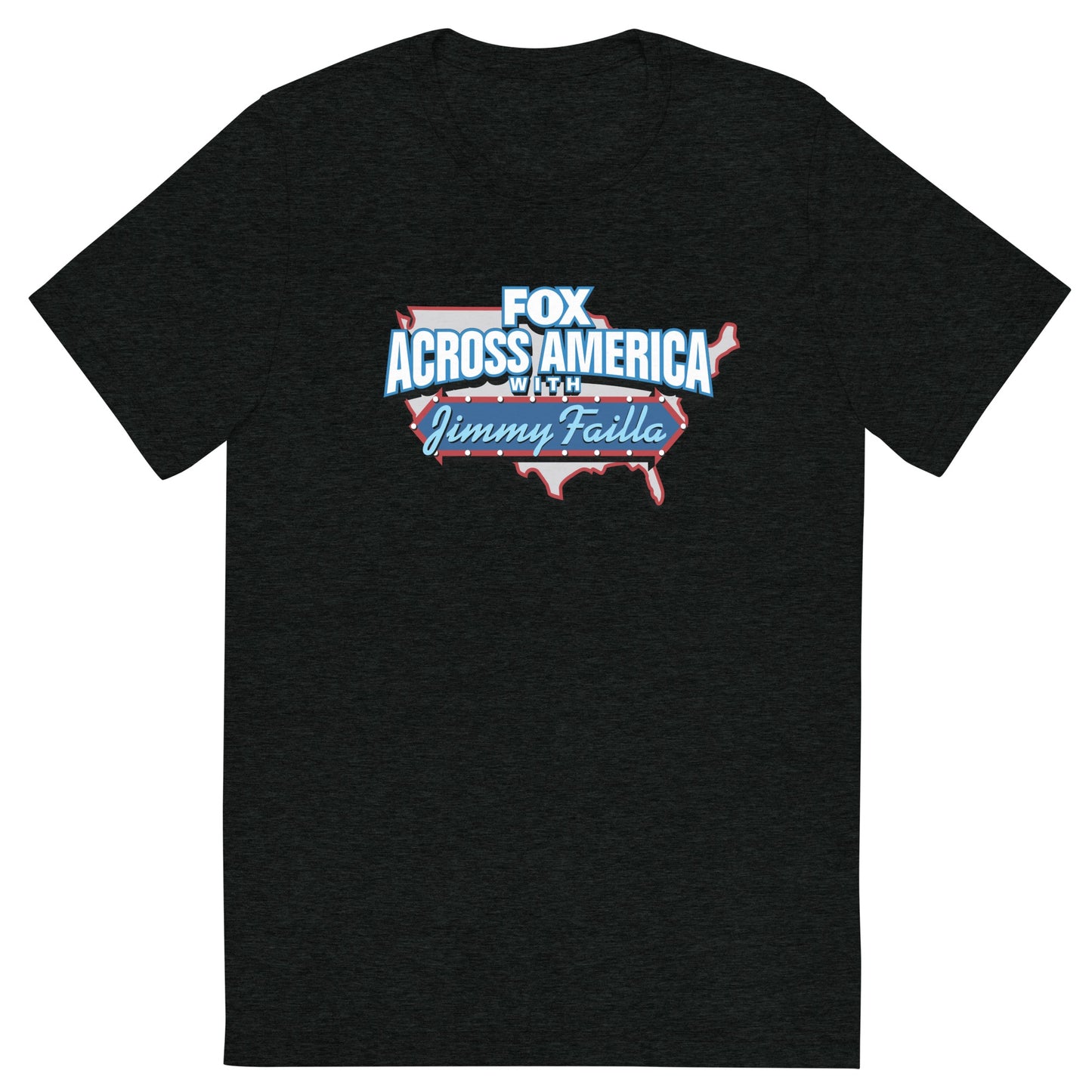 A man in a modern American living room wearing the charcoal tri-blend FOX Across America T-shirt featuring the Jimmy Failla graphic.
