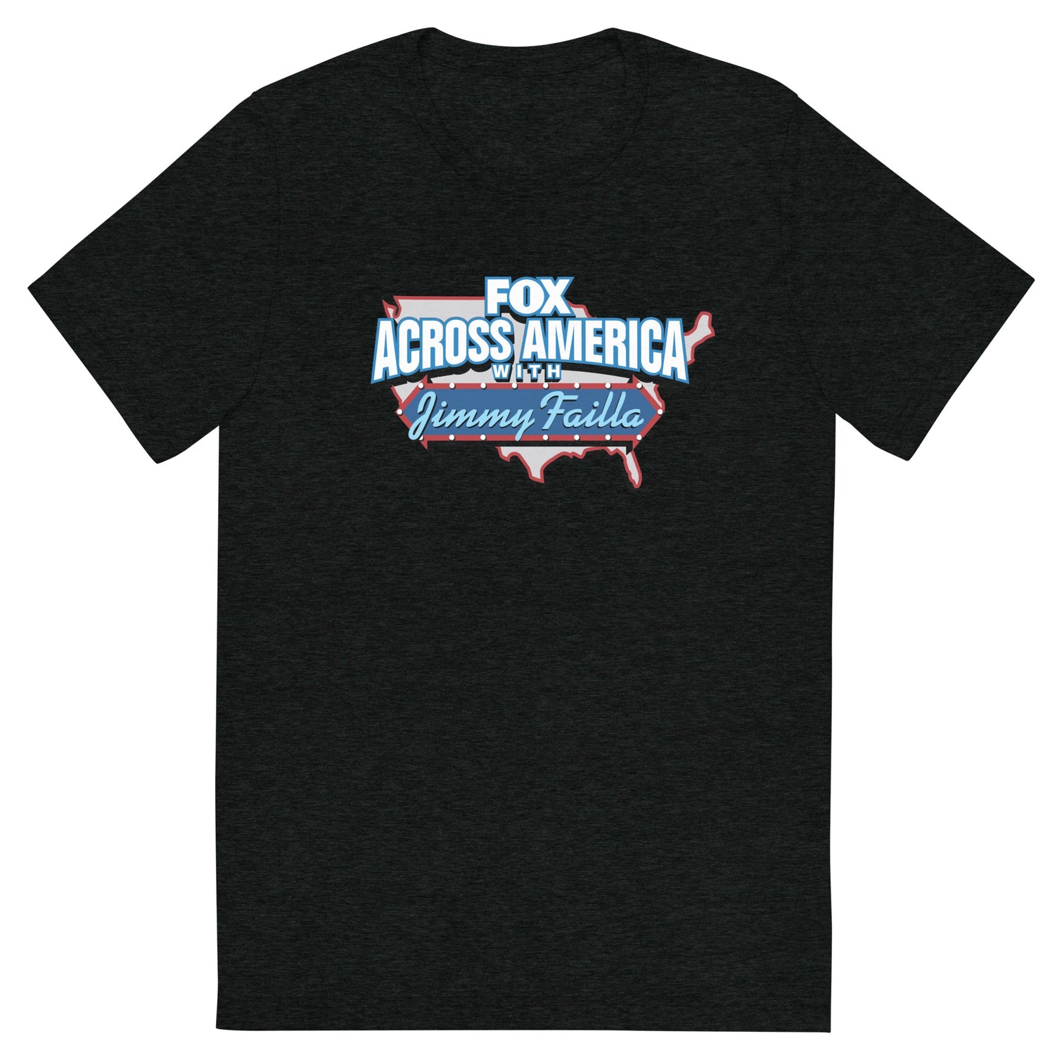 A man in a modern American living room wearing the charcoal tri-blend FOX Across America T-shirt featuring the Jimmy Failla graphic.