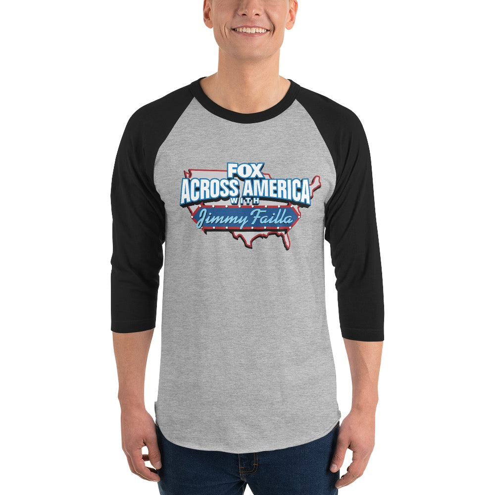 A woman wearing the FOX Across America three-quarter sleeve baseball tee in a modern, suburban home setting.