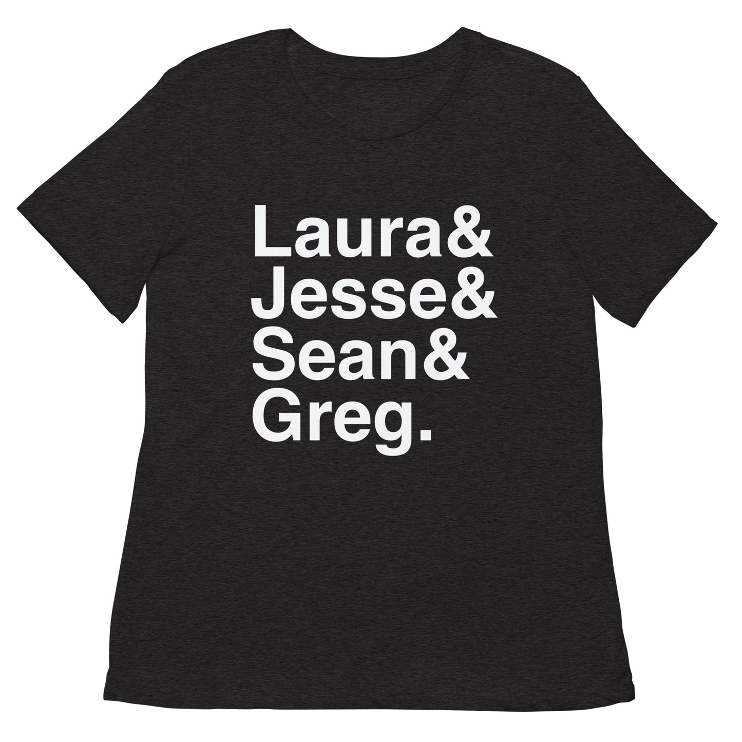 A woman wearing the FOX News Ampersand Women's Tri-Blend T-Shirt in Dark Grey Heather, standing in a bright, clean American suburban home setting.