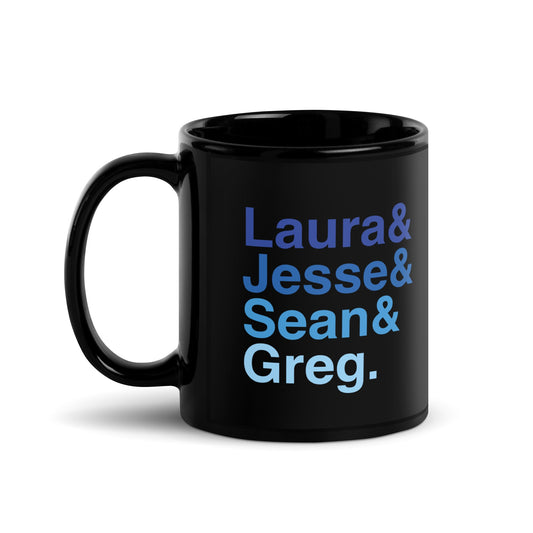 A sleek FOX News black glossy mug with a bold white ampersand design sitting on a clean American kitchen counter.
