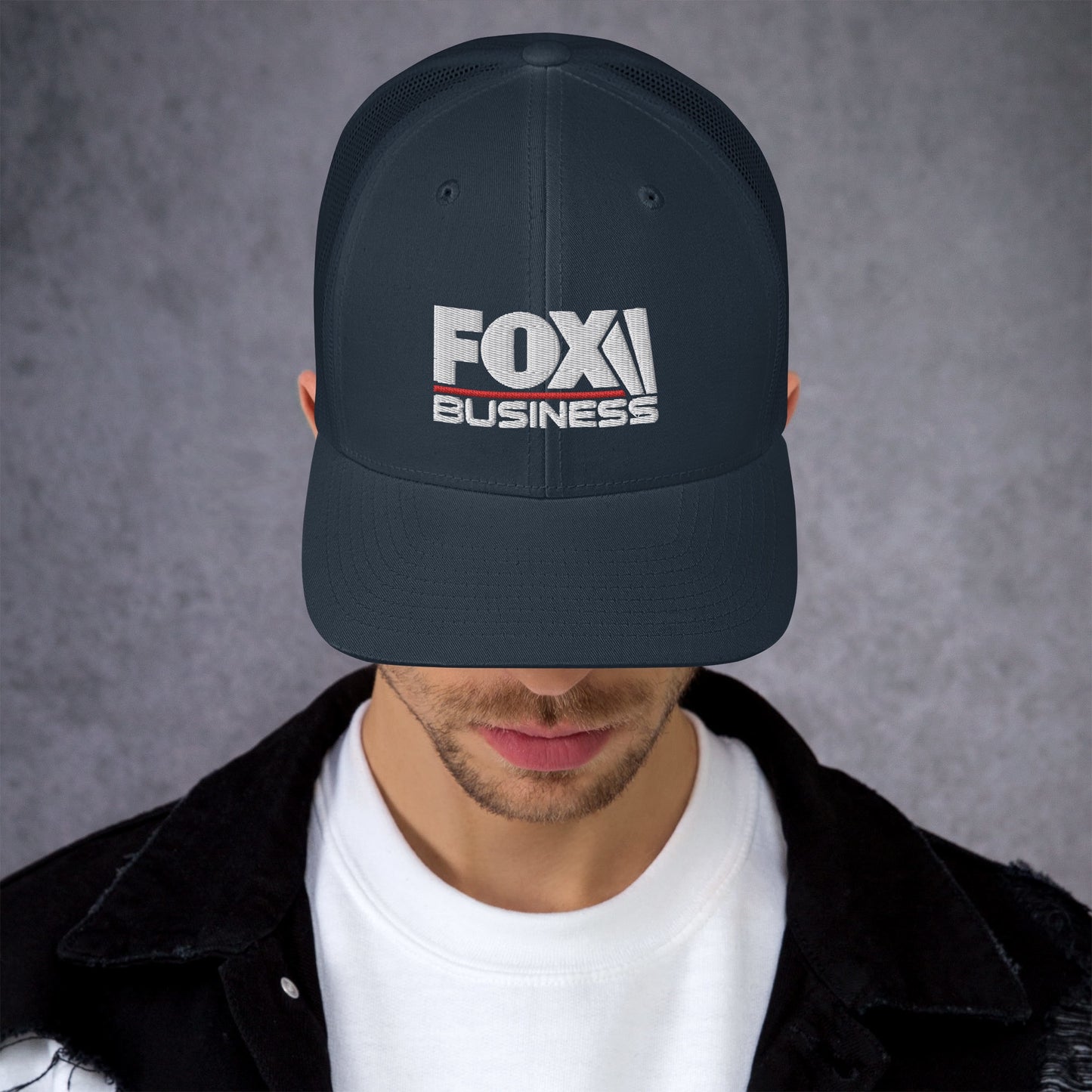 A man wearing the black FOX Business logo hat during a bright morning walk in an American neighborhood.