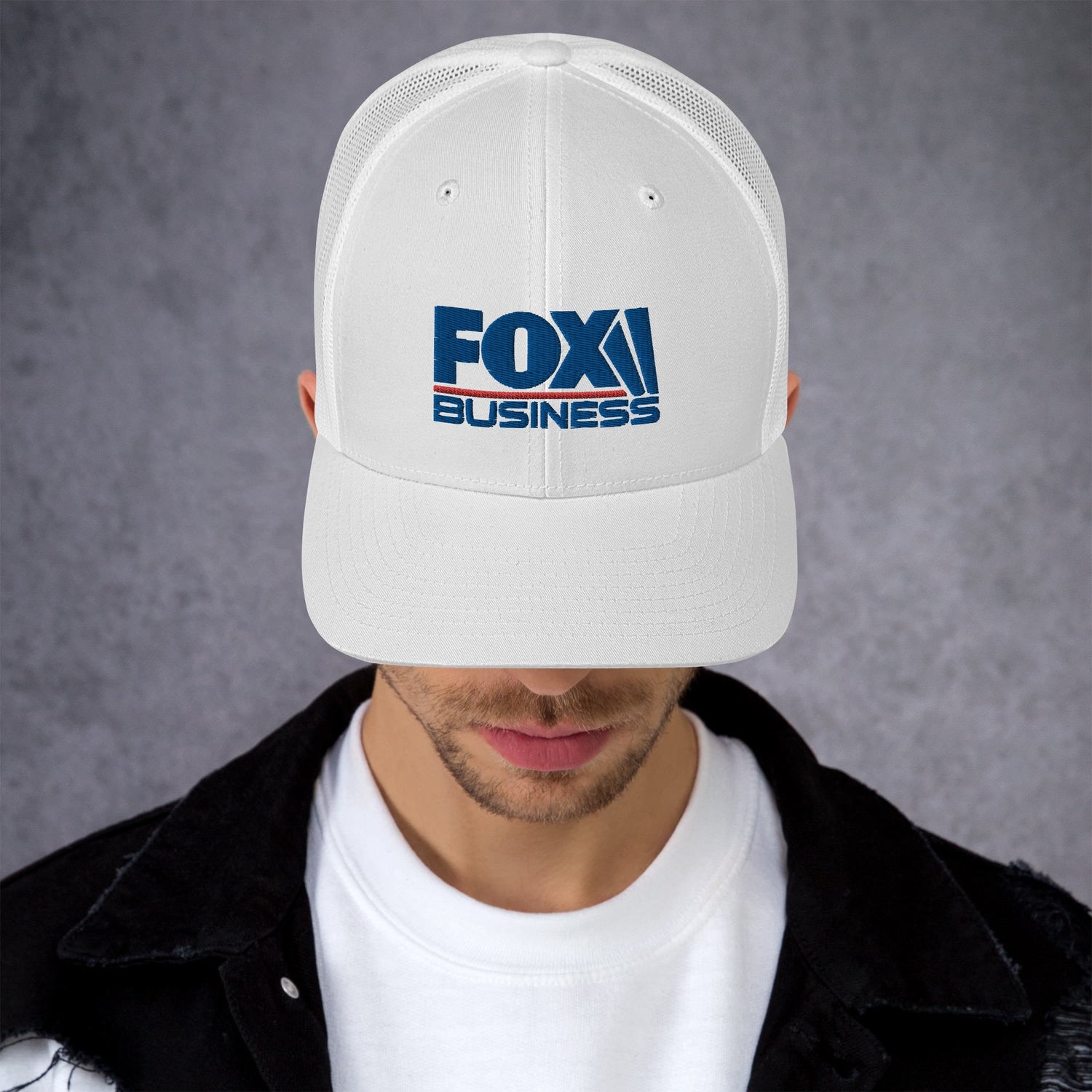 The FOX Business logo hat resting on a wooden table in a bright, modern American home setting.
