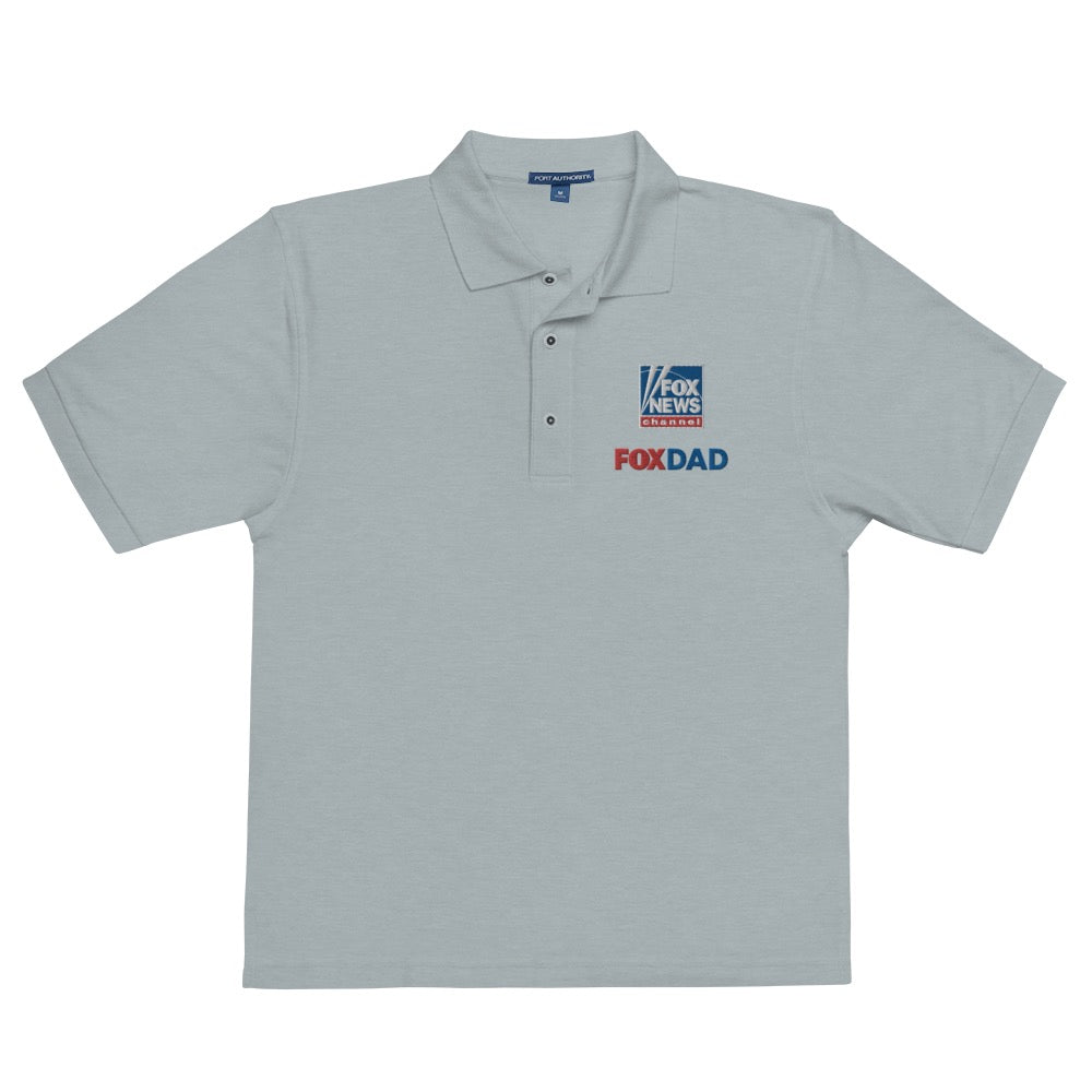 An outdoor suburban backyard patio setting during a bright morning, featuring the FOX News Dad Embroidered Polo Shirt folded neatly on patio furniture.