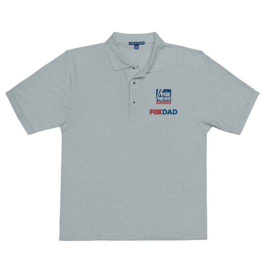 An outdoor suburban backyard patio setting during a bright morning, featuring the FOX News Dad Embroidered Polo Shirt folded neatly on patio furniture.