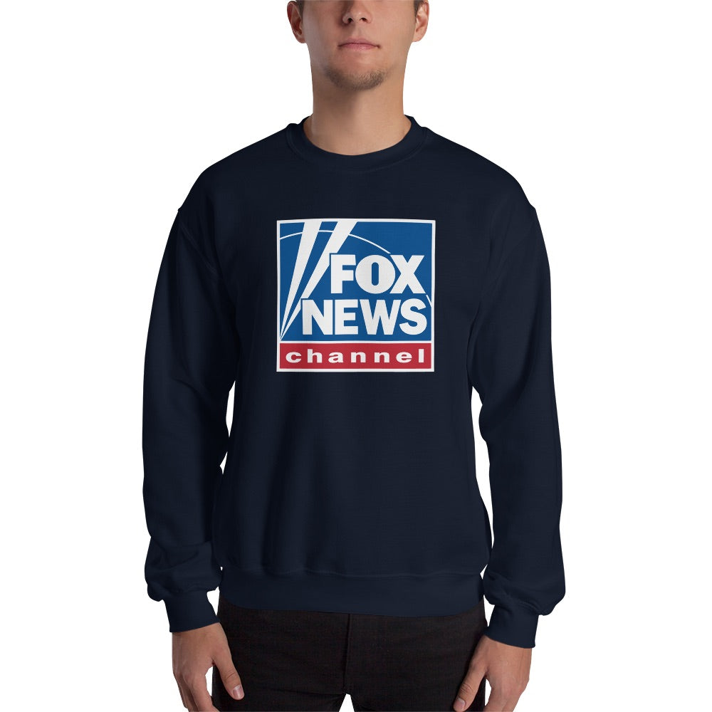 A woman in a clean American home setting wearing a red FOX News Logo Crewneck Sweatshirt while holding a mug.