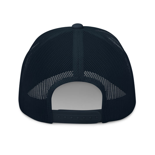 A clean outdoor backyard morning coffee setting featuring the navy and white FOX News embroidered trucker hat.