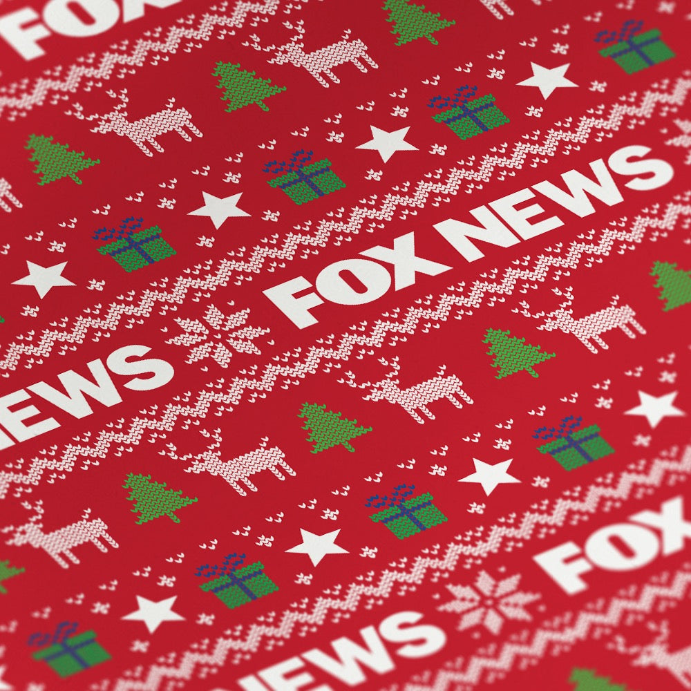 Close-up of the high-quality *FOX News* logo printing on holiday wrapping paper in a clean home setting.