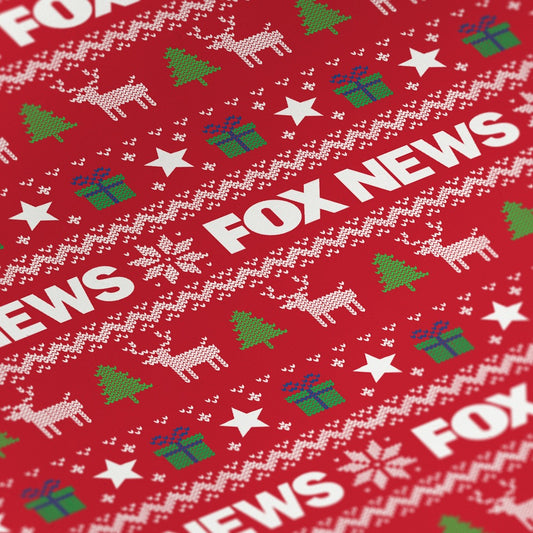Close-up of the high-quality *FOX News* logo printing on holiday wrapping paper in a clean home setting.
