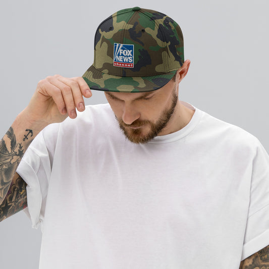 Side view of a camouflage FOX News hat showing the adjustable snapback closure in a suburban setting.