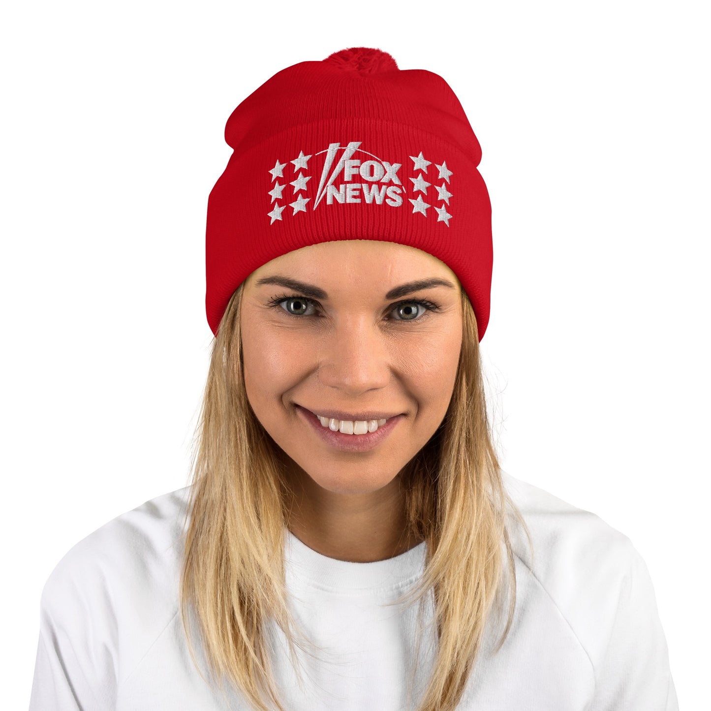 A person wearing the FOX News embroidered pom pom beanie while standing outside in a suburban winter context.