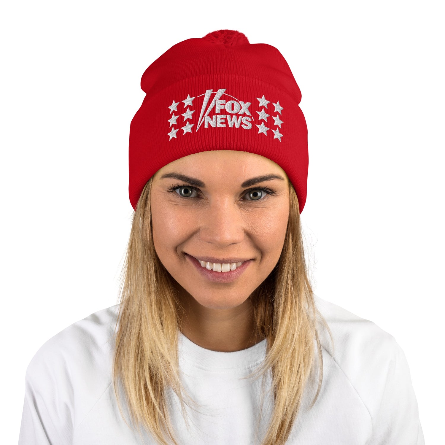 A person wearing the FOX News embroidered pom pom beanie while standing outside in a suburban winter context.
