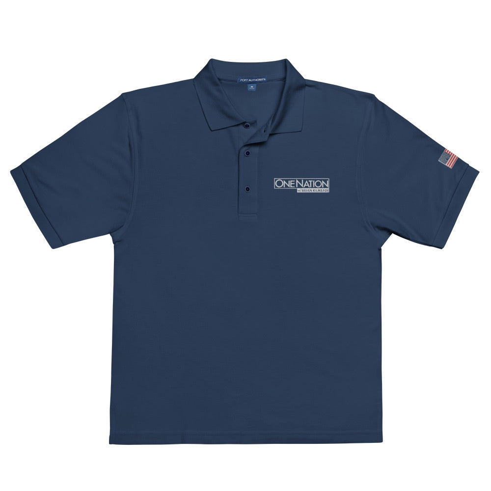 A man wearing the Navy FOX News One Nation embroidered polo shirt in a clean American backyard setting.