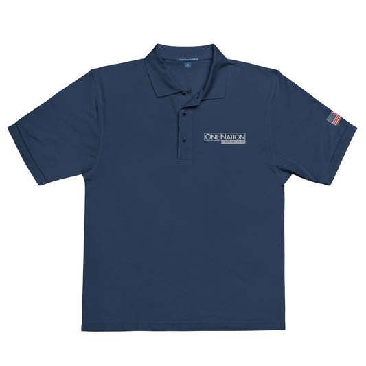 A man wearing the Navy FOX News One Nation embroidered polo shirt in a clean American backyard setting.