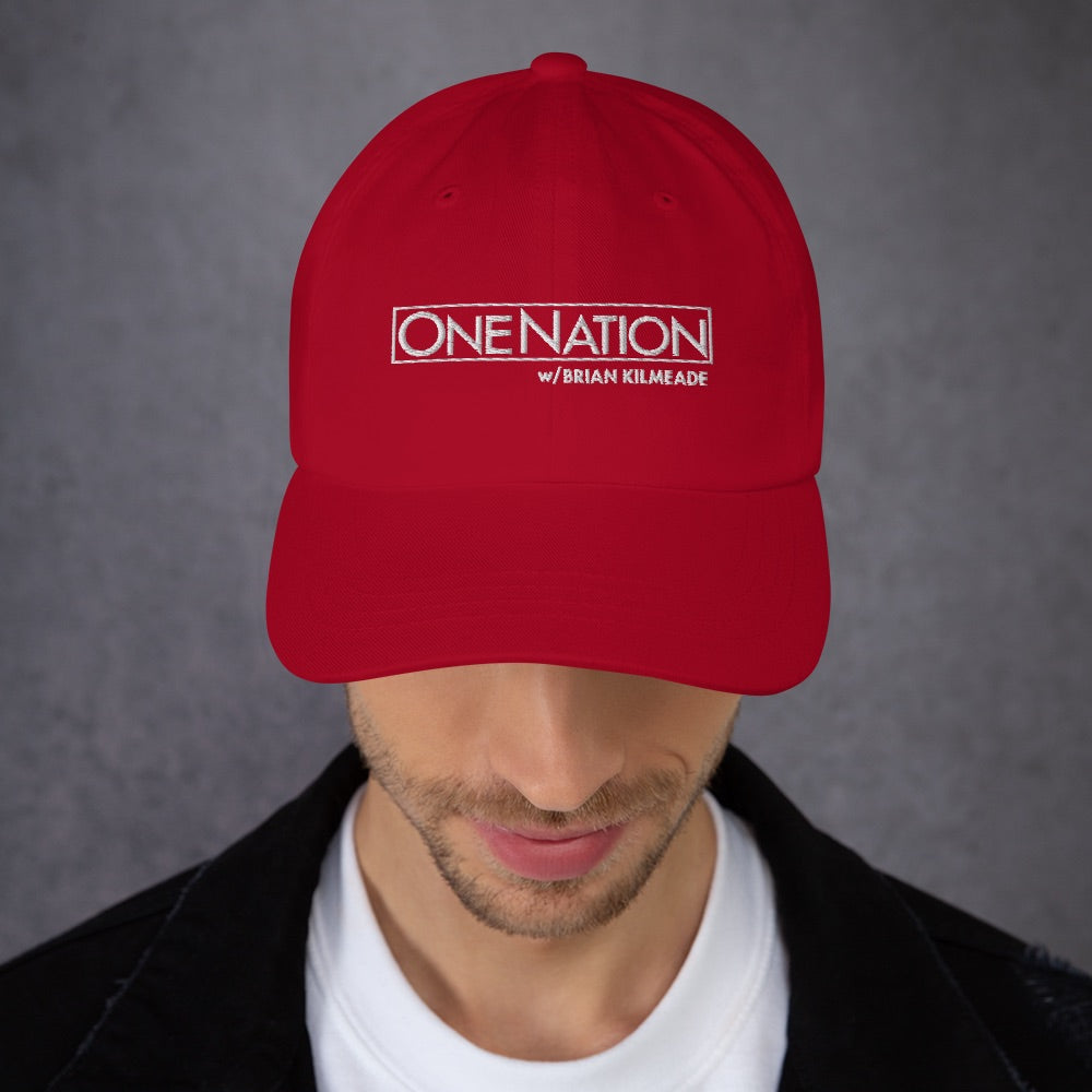 An angled lifestyle shot of the FOX News hat resting in a bright, modern American living room setting.
